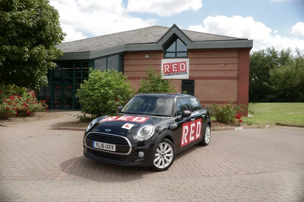 RED mini parked outside RED driving school